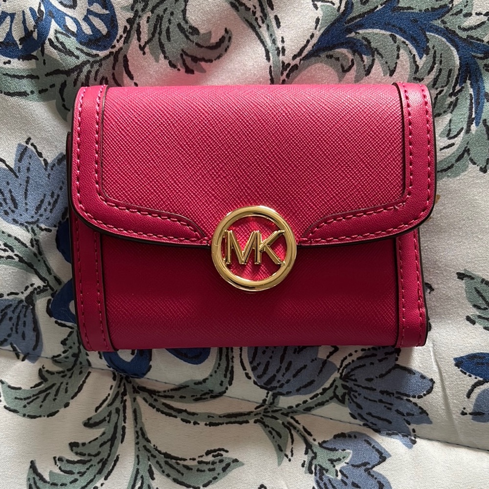 Michael Kors Pink Wallet with Gold Emblem and Flap Closure